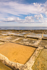 Wall Mural - Salt pans on the beach in gozo, Malta