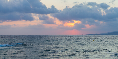 Wall Mural - Mediterranean Sea is under cloudy sky on a sunset. Propriano, Corsica