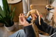 © LIGHTFIELD STUDIOS - Cropped view of artist holding wooden doll in workshop