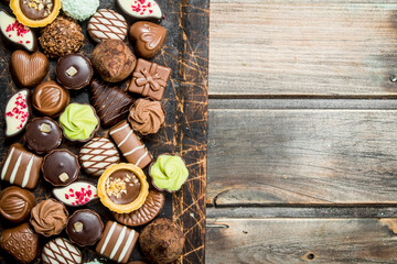 Wall Mural - Chocolate sweets on a wooden Board.