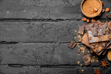 Poster - Assortment of different types of chocolate with cocoa powder.