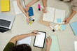 © DragonImages - Group of students doing homeworks for math class, view from above