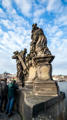 Canvas Print - Taking a photograph in Karlov Bridge, Prague Bridges in the Summer on the Sunset. Czech Republic.