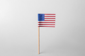 Canvas Print - Small paper flag of USA on light background. Space for text