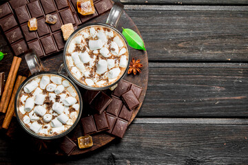 Poster - Hot chocolate in mugs with marshmallows and fragrant cinnamon.