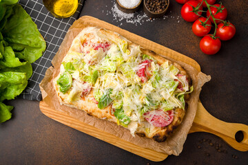 Wall Mural - Roman pizza, Pinsa caesar with chicken and salad on roman dough top view