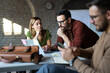 © Novak - Business people discussing over new business project in office