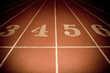 © Cavan Images - Numbered start line of a running race track in Toronto, Ontario.