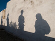 © Cavan Images - Shadows of tourists as they walk/photograph in  Fira, Santorini, Greece