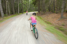 Two Children Bike The Carriage Roads At Acadia Nationa Park In Maine. (blurred Motion)