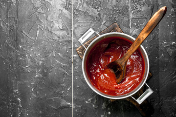 Sticker - Tomato sauce in a pot with a wooden spoon.