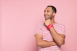 © New Africa - Portrait of happy African American man on pink background. Space for text