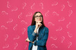 canvas print picture - Choice in profession or other areas of life, concept. Making decision, thoughtful young woman surrounded by drawn question marks on pink background