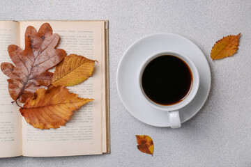 Sticker - Cup of hot drink, book and autumn leaves on light grey textured table, flat lay