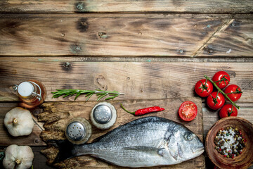 Wall Mural - Raw sea fish with tomatoes and herbs.