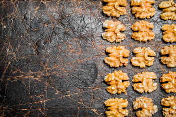 Wall Mural - Peeled walnut on wooden background.