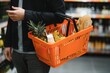© Serhii - Handsome man buying some healthy food and drink in modern supermarket or grocery store. Lifestyle and consumerism concept.