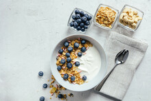 Yogurt With Muesli And Berries On A Gray Background.