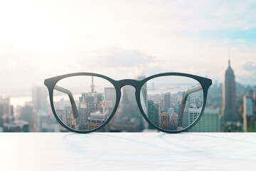 Fototapete - Look through eyeglasses at blurred city with mock up place on sky backdrop. Vision and perspective concept. 3D Rendering.