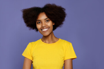 Wall Mural - Portrait of smiling African American woman on purple background