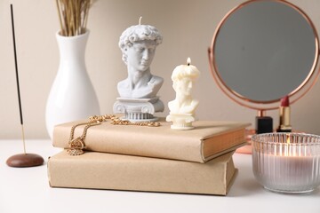 Wall Mural - Beautiful David bust candles and books on white dressing table