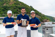 © CandyRetriever  - Portrait of Waiter and waitress holding food and drink for serving to passenger tourist travel on luxury private catamaran boat yacht on summer vacation. Cruise ship service occupation concept.