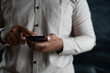 © berkahjayamaterial - business man holding a mobile phone