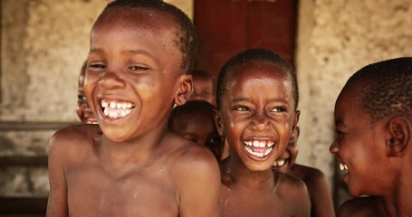 Wall Mural - A Group Of African Children, Laughing, Jumping and Playing in Rural Area. Little Faces Full Of Joy and Life After Having Fun Playing with Water and Getting Refreshed in Summer Hot Weather