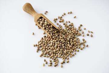  natural hemp seeds on a white acrylic background