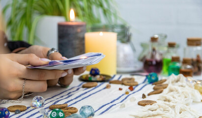 A fortune teller reads with tarot cards. Selective focus.