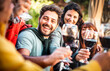 © Mirko Vitali - Happy people on genuine mood drinking red wine at pic nic garden party - Millenial friends having fun together at restaurant winery bar out side - Dining life style concept on bright warm filter