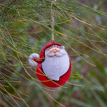 Hand-painted Santa Claus Christmas Decoration Hanging In A Tree