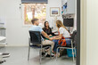 © Austockphoto - female doctor talking to male and female patients in a clinic