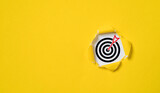 Fototapeta  - Dartboard with arrow inside of yellow punched paper for setup business objective target and goal concept.