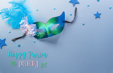 Happy Purim carnival decoration concept made from mask and sparkle star and hamantaschen cookies on pastel background. (Happy Purim in Hebrew, jewish holiday celebrate)