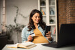 © JustLife - Pregnant woman shopping online at home. Happy woman with laptop and credit card.