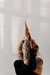 Closeup of Woman with tattoos practicing Yoga with white background