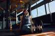 © Flamingo Images - Woman sitting on the floor of a gym