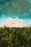 Fototapeta Sypialnia - View from above, stunning aerial view of a person wlking on a beautiful beach bathed by a turquoise rough sea at sunset, Green Bowl Beach, South Bali, Indonesia..