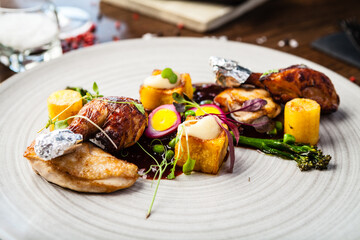 Chicken fillet, Jerusalem artichoke puree, dewberry sauce, potato, quail egg. Delicious healthy traditional food closeup served for lunch in modern gourmet cuisine restaurant