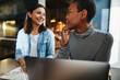 © Flamingo Images - Smiling female entrepreneurs working in a cafe together