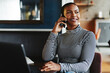 © Flamingo Images - Smiling female entrepreneur talking on her cellphone in a cafe