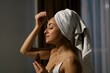 © Nataliya - Side view of pretty young joyful female using facial serum. Beautiful woman applying moisturizing serum product on face skin. Home beauty treatment. Skincare and beauty. Close up