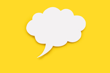 Speech bubble in the form of a cloud on a yellow background. Free space for text. Empty white speech bubble with text writing option. The concept of speech communication on the Internet between people