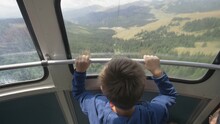 Curious Child Head Looking Outside Cable Cab, Gorgeous Mountain Panorama