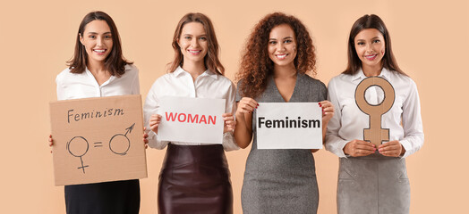 Wall Mural - Young women on beige background. Concept of feminism