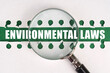 Between two sheets from a notebook on a green strip with the inscription - environmental laws