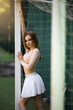 portrait of glamorous young woman in soccer goal
