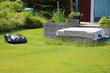 Robotic lawnmower and raised beds in the garden, Sweden