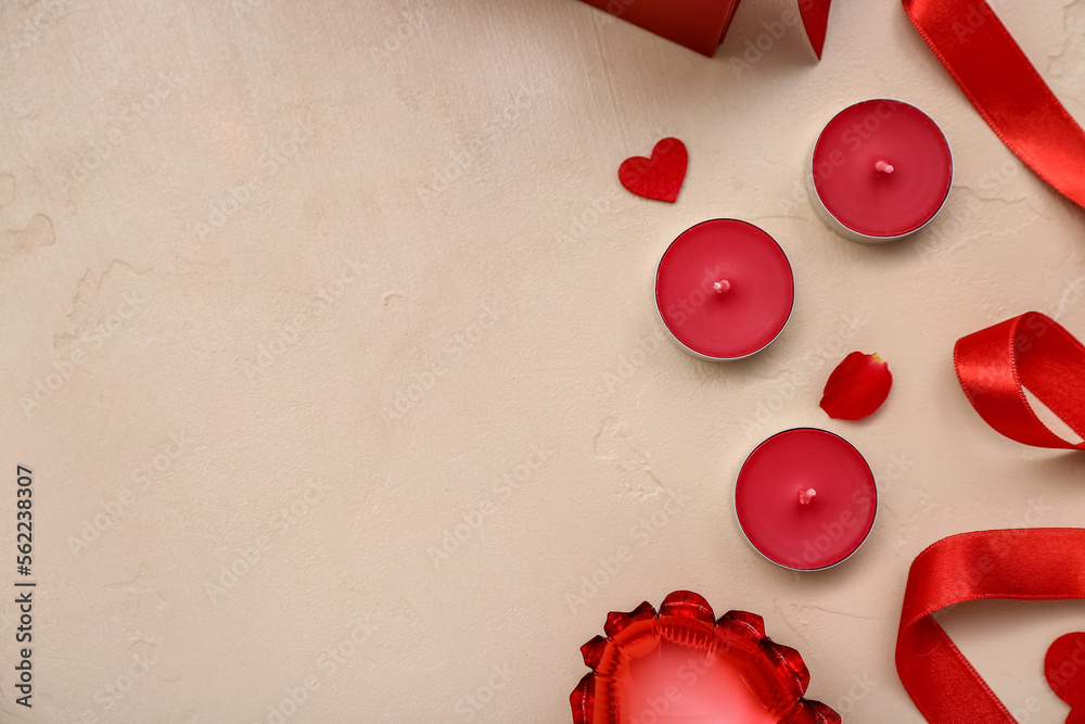 Composition with candles and red ribbon on color background. Valentine's Day celebration
